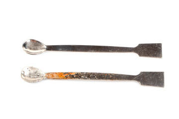 Damaged with oxidation metal laboratory spoon, spatula isolated on white background. Metal Laboratory Equipments. Lab spatulas reagent lab sampling used in laboratory.
