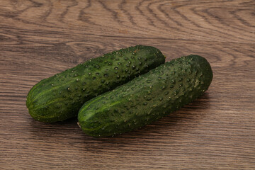 Green fresh cucumbers over background