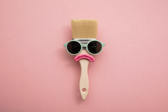 Paint brush diy character with sunglasses and sad face