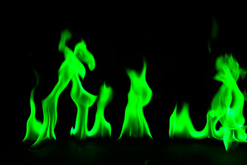 Abstract green fire flames on black background.