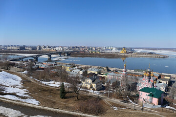 A panoramic image on a bridge over a river in a port city with modern buildings and churches. High quality