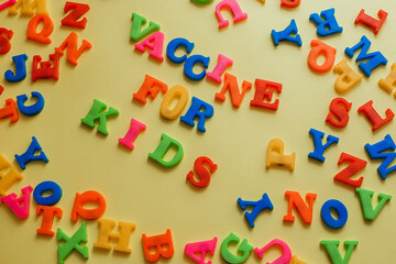 the word vaccine on a yellow background. Vaccination concept