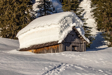 Mountain huts covered in layers of snow	