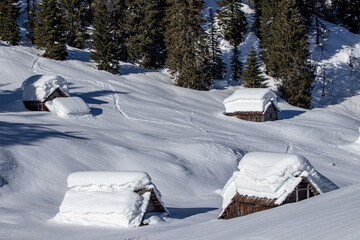 Fototapeta na wymiar Mountain huts covered in snow, Jezero 