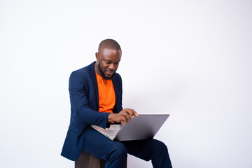 Naklejka na ściany i meble handsome young black man using a laptop