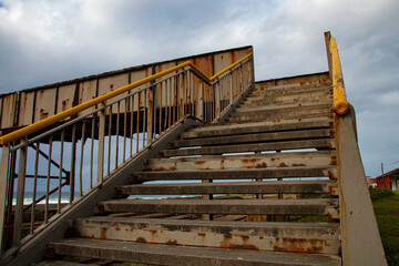 Obraz premium Rusty Steel Pedestrian Bridge over Railway Line