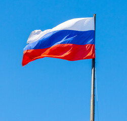 Naklejka na ściany i meble Flag of the Russian Federation against a sky.