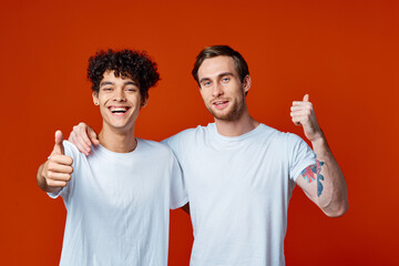 two man in white t-shirts fun emotions hand gestures friendship hugs