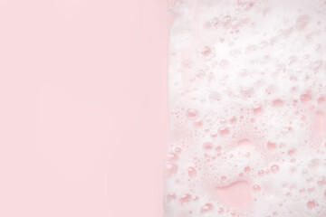 White foam bubbles texture on pink pastel background, copy space, banner for loundry, cleaning service, bathroom concept, clean, wash - liquid soap, shower gel, shampoo - 428105391