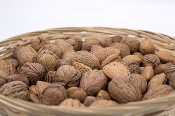 Close-up of assorted nuts in a basket.
Product: walnuts, almonds, hazelnuts.
