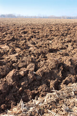 Freshly plowed field in winter season. Rural scene 