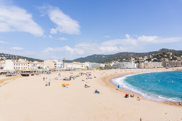 Image of people with protective masks on the beach of TOSSA DE MAR