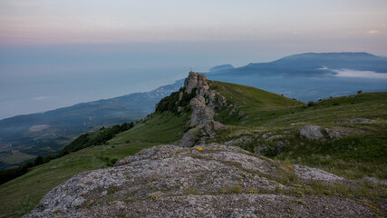 Walking in the mountains.Mount Demerdzhi in the Crimea. Sunset on the mountain. Fog in the mountains.