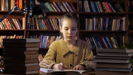 Exhausted young lady writes home assignment in copybook with brown pencil sitting among different books at home in late evening closeup