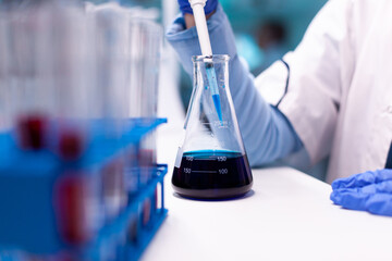 Closeup research of professional scientist taking a sample from test tube with micropipette . Pharmacy scientist doctor discovery scientific disease with biotechnology professional equipment.