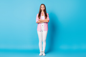 Photo of self-assured charming lady crossed hands look camera wear pink striped shirt pants shoes isolated blue background