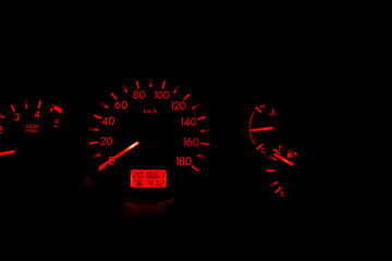 Speedometer dial with red numbers and the black background represents the speed of the car. Engine...