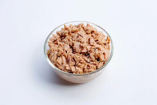 Canned tuna in glass bowl on white