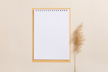 Mock-up Planning. Copy space. 'To do' or shopping list in natural eco-friendly style. Wish list. Blank notebook with white paper and dry pampas grass on crumpled brown kraft-paper background. 