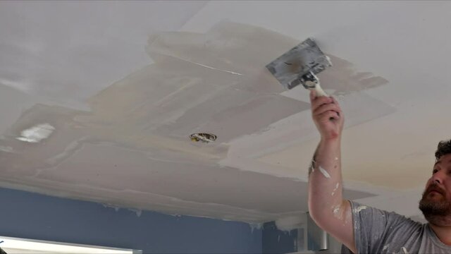 Home interior renovation on coating plastering wall putty plaster on the wall ceiling