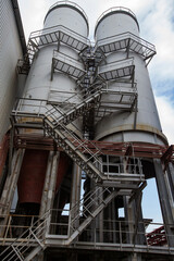 Glass factory Darkhan. New industrial building construction. Smoking stacks with stairs. Shymkent city, Kazakhstan