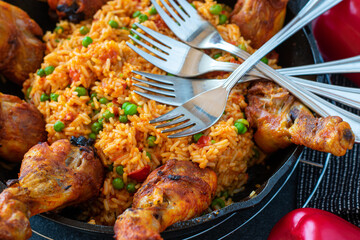 grilled chicken drumsticks with serbian djuvec rice in a cast iron skillet