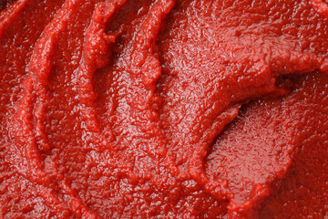 Tasty tomato paste on whole background, close up