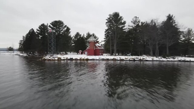 4k drone video of Sandpoint Lighthouse in Baraga, Michigan in the winter.