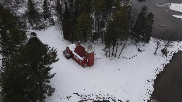 4k drone video of Sandpoint Lighthouse in Baraga, Michigan in the winter.
