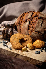 Liver and bread next to a jar on a wooden stump on a brown background