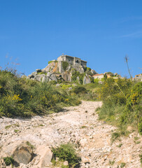 Fototapeta premium walk in the mountains. stone road in the mountains to the top where the large monastery is located.