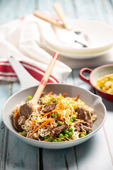 Beef stir fry with wooden spoon