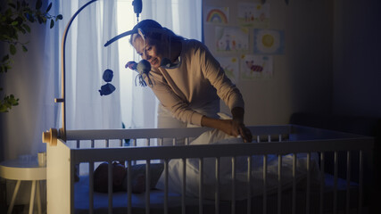 Authentic Shot of a Mother Soothing and Cuddling a Newborn Baby Boy in Child Crib. Caucasian...