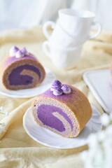 Swiss Roll Cake with sweet purple potato filling set on cafe table.