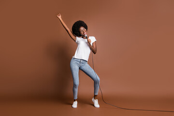 Fototapeta na wymiar Full length body size photo of girl dancing at party singing in the club enjoying party isolated on brown color background