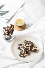 crunchy brittle brownie crisps crackers set on white cafe table.
