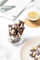 crunchy brittle brownie crisps crackers set on white cafe table.
