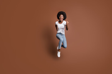 Fototapeta na wymiar Full length body size photo of girl jumping running fast on sale black friday isolated on brown color background