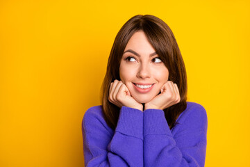 Photo of dreamy cute young woman wear purple pullover arms cheeks looking empty space isolated yellow color background