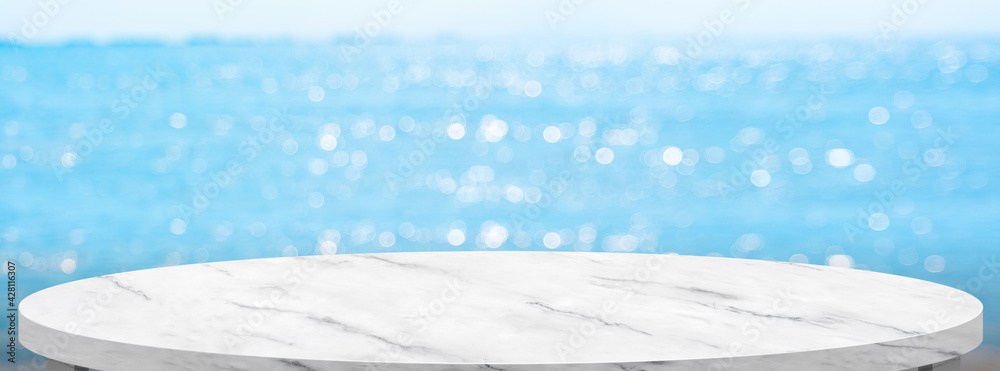 Poster empty round marble table with summer blue sea blur background.copy space for display of product on o