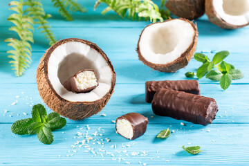Glazed cheese curds with chocolate and coconut on a blue background. Sweet breakfast or dessert.