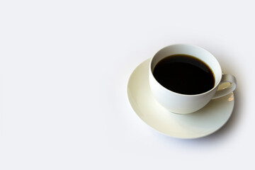 Morning coffee in a white cup on a white saucer.