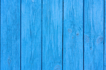 Fototapeta premium Old blue wooden wall of a house with cracked oil paint. Bright colorful vintage wood background