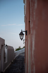 Narrow street with an old style street lamp hanging low