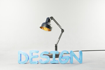 black industry style desk lamp on grey colored surface with clay stylized lettering design; concept 3D artist design; 3D Illustration