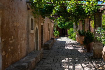 Fototapeta na wymiar A shaded back yard with grapevines covering from the sun. Crete island, Greece