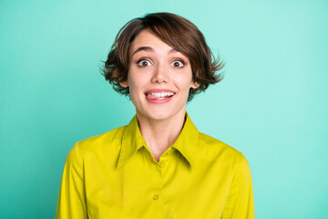 Photo portrait of playful childish female student staring showing tongue isolated on vibrant turquoise color background