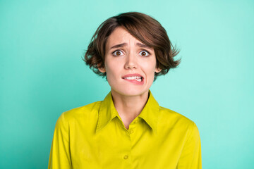 Portrait of attractive scared miserable girl biting lip bad news isolated on bright blue color background