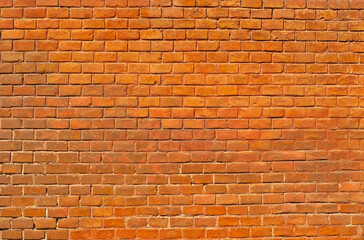 Naklejka na ściany i meble Texture of brick wall. Samples of wall or fence are presented at exhibitions. Orange brick close up.