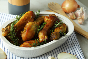 Concept of delicious eating with baking tray with roast chicken drumsticks